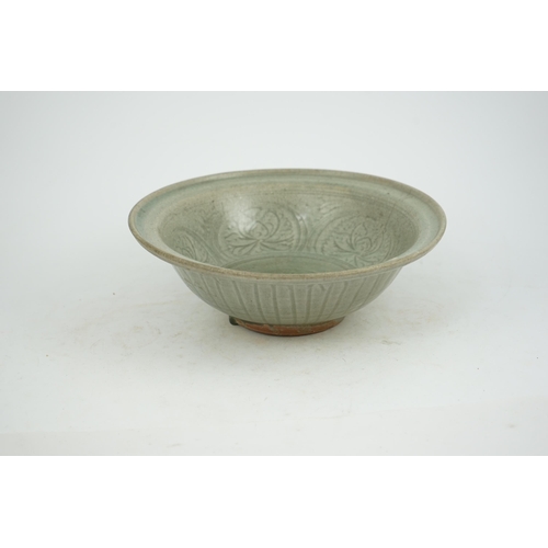 66 - A large Thai celadon glazed bowl, Sawankhalok kilns, 14th / 15th century, heavily-potted with flared... 