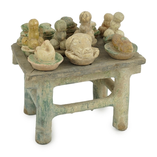 72 - A Chinese glazed pottery altar table with food offerings, Ming Dynasty, c.1550-1600, the table is la... 