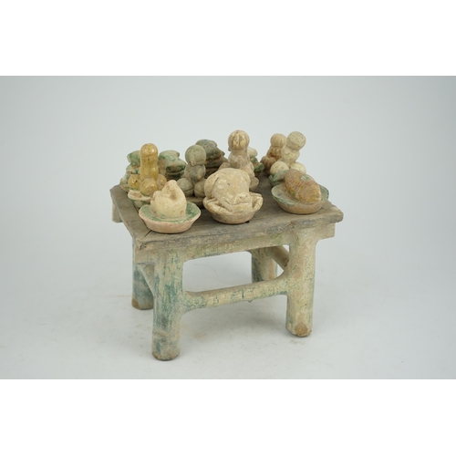 72 - A Chinese glazed pottery altar table with food offerings, Ming Dynasty, c.1550-1600, the table is la... 