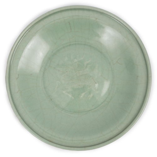 98 - A Chinese Longquan celadon 'qilin' dish, 15th/16th century, the centre moulded with the figure of a ... 