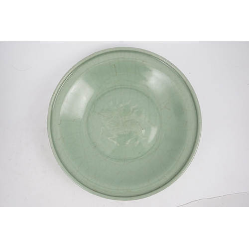 98 - A Chinese Longquan celadon 'qilin' dish, 15th/16th century, the centre moulded with the figure of a ... 