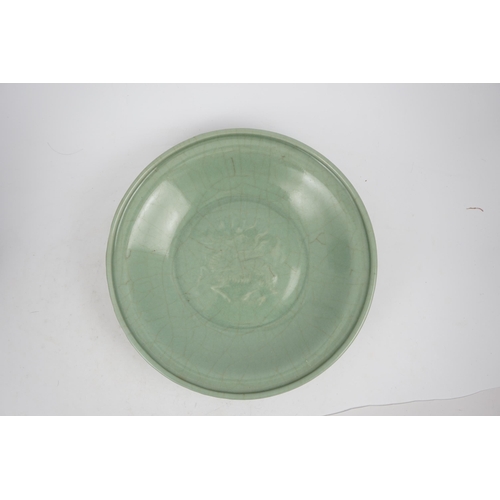 98 - A Chinese Longquan celadon 'qilin' dish, 15th/16th century, the centre moulded with the figure of a ... 