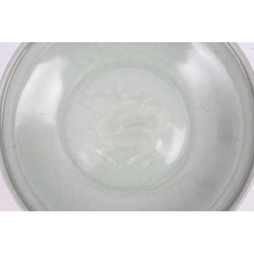 98 - A Chinese Longquan celadon 'qilin' dish, 15th/16th century, the centre moulded with the figure of a ... 