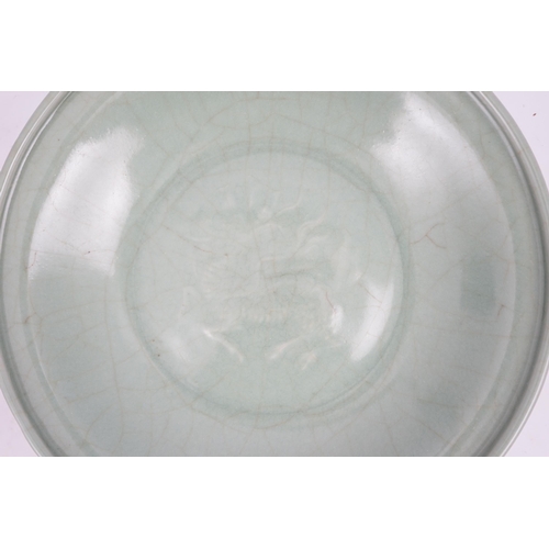 98 - A Chinese Longquan celadon 'qilin' dish, 15th/16th century, the centre moulded with the figure of a ... 