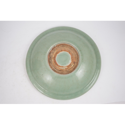 98 - A Chinese Longquan celadon 'qilin' dish, 15th/16th century, the centre moulded with the figure of a ... 