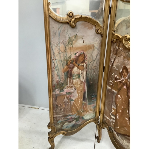 1055 - An early 20th century French carved giltwood three fold dressing screen with inset painted and print... 