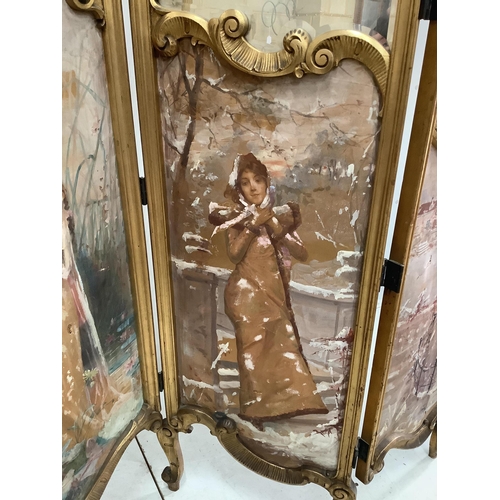 1055 - An early 20th century French carved giltwood three fold dressing screen with inset painted and print... 