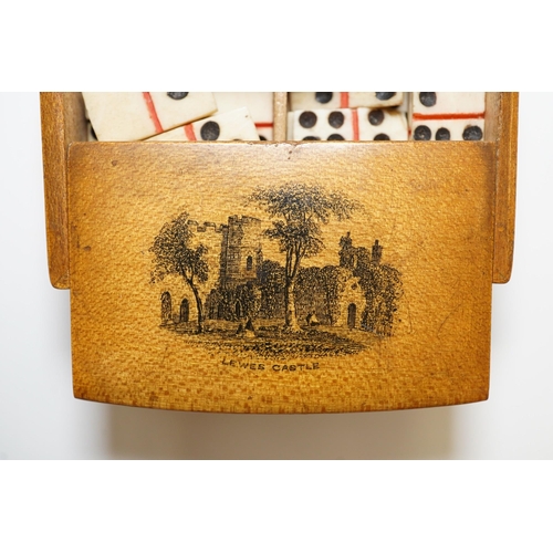1436 - A Mauchline ware Lewes Castle box containing a full set of bone dominoes, 5cm. Condition - fair to... 