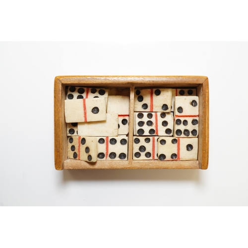 1436 - A Mauchline ware Lewes Castle box containing a full set of bone dominoes, 5cm. Condition - fair to... 