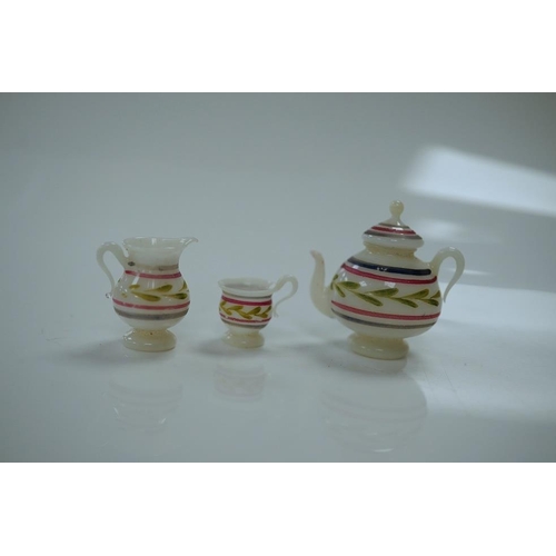 1440 - A mixed collection of miniature items including a hound whistle, a candle snuffer and a glass tea se... 