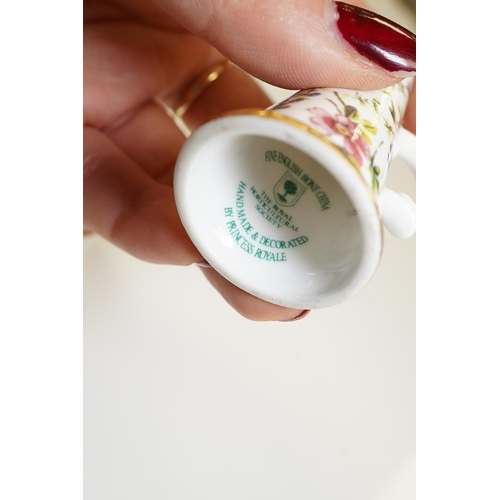 1440 - A mixed collection of miniature items including a hound whistle, a candle snuffer and a glass tea se... 