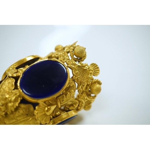 1442 - A 19th century Pinchbeck posy holder with mother of pearl handle and inset blue glass panels. Condit... 