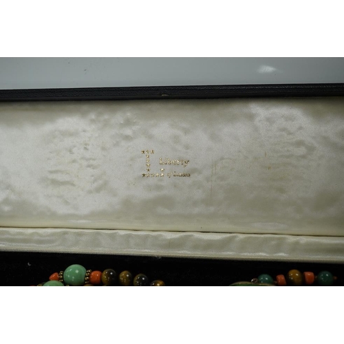 1450 - A Chinese silver and enamel amulet tiger's eye, coral and turquoise bead necklace, housed in a liber... 