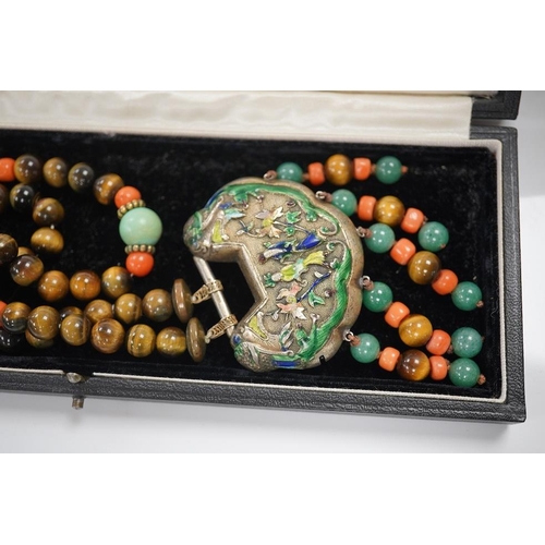 1450 - A Chinese silver and enamel amulet tiger's eye, coral and turquoise bead necklace, housed in a liber... 