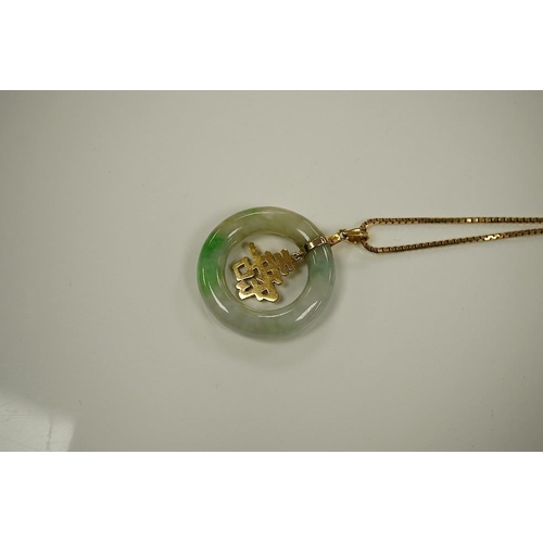 1453 - A Chinese jadeite and gold circular pendant and box link chain, stamped 585. Condition - good