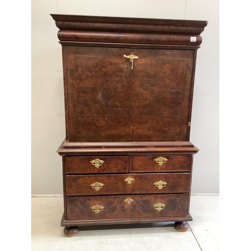 104 - A Queen Anne escritoire, with three long graduated drawers, fall front opening to reveal drawers and... 