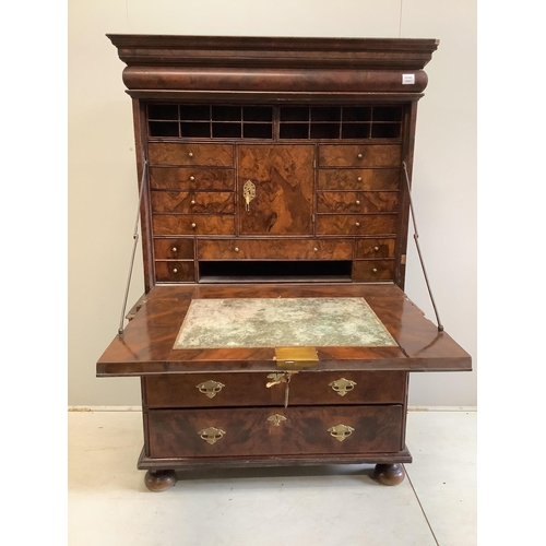 104 - A Queen Anne escritoire, with three long graduated drawers, fall front opening to reveal drawers and... 