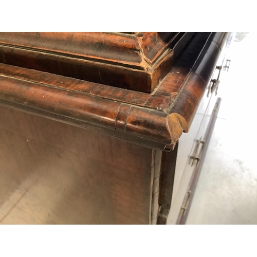 104 - A Queen Anne escritoire, with three long graduated drawers, fall front opening to reveal drawers and... 