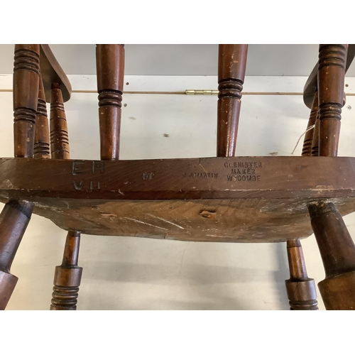 14 - A pair of early 20th century elm and beech smokers bow chairs by Glenister, Wycombe, one bears Edwar... 