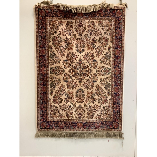 22 - A Karastan Sarouk style ivory ground rug, 190 x 133cm. Condition - fair