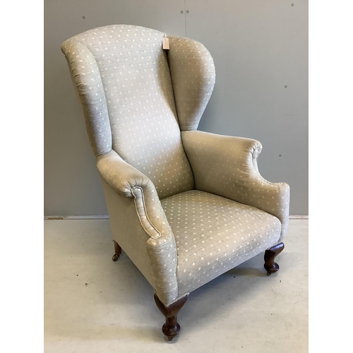 57 - An early 20th century upholstered wing armchair, width 80cm, depth 80cm, height 124cm. Condition - f... 