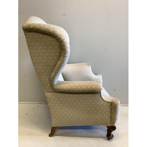 57 - An early 20th century upholstered wing armchair, width 80cm, depth 80cm, height 124cm. Condition - f... 