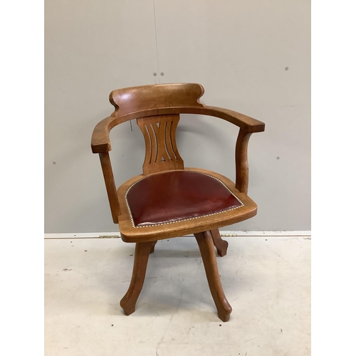 62 - An early 20th century oak swivel desk chair with leather seat, width 61cm, depth 52cm, height 87cm. ... 