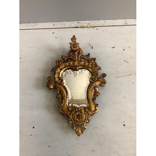 83 - A pair of cartouche shaped carved giltwood wall mirrors, width 31cm, height 51cm. Condition - poor t... 