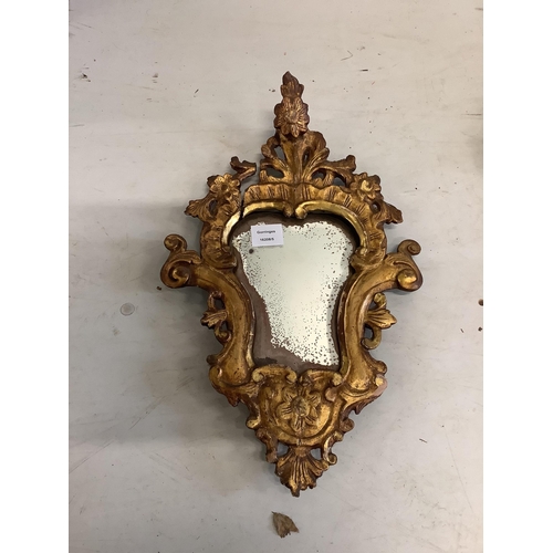 83 - A pair of cartouche shaped carved giltwood wall mirrors, width 31cm, height 51cm. Condition - poor t... 