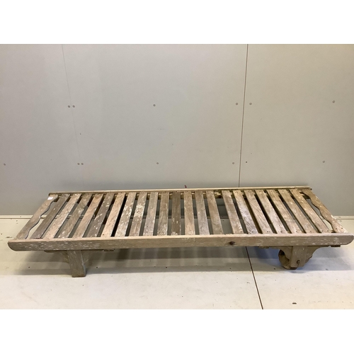 95 - A weathered teak lounger, possibly Lister, width 64cm, length 195cm. Condition - poor