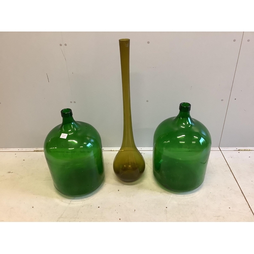 97 - A pair of large green glass carboys, height 60cm together with a tall glass vase. Condition - fair t... 