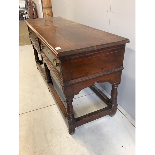 98 - An 18th century oak low dresser base with two long drawers, width 150cm, depth 53cm, height 77cm. Co... 