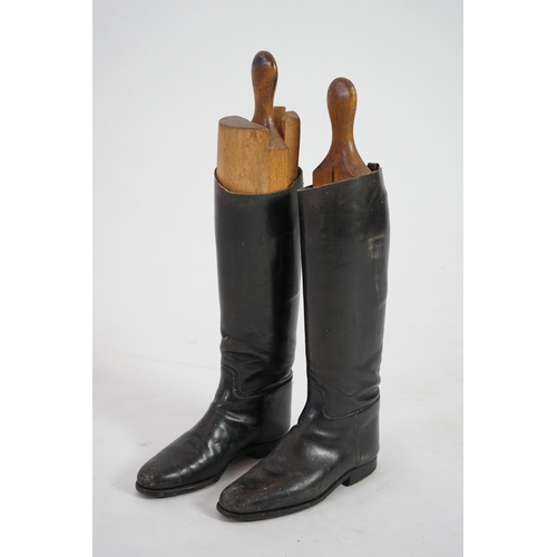 12 - A pair of black leather riding boots with wooden tree liners, overall 61cm high