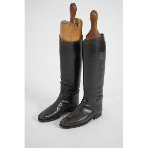 12 - A pair of black leather riding boots with wooden tree liners, overall 61cm high