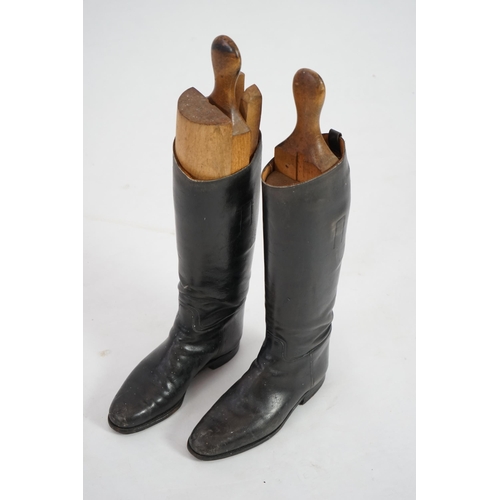 12 - A pair of black leather riding boots with wooden tree liners, overall 61cm high