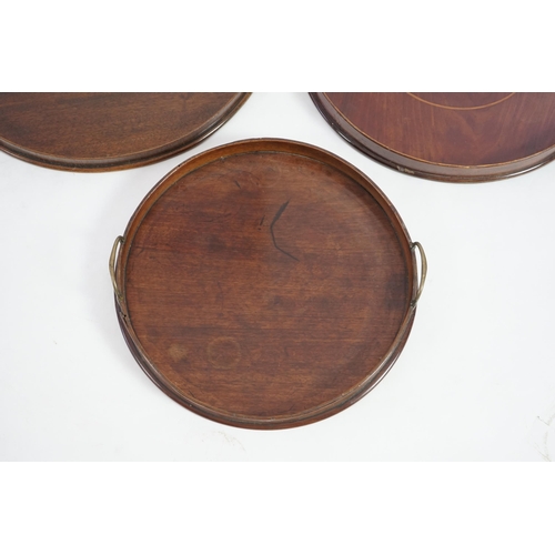 20 - Three George III and later circular mahogany gallery trays, each with brass loop handles, largest di... 