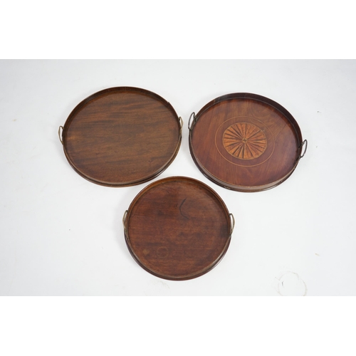 20 - Three George III and later circular mahogany gallery trays, each with brass loop handles, largest di... 