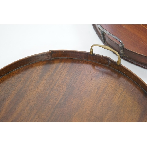 20 - Three George III and later circular mahogany gallery trays, each with brass loop handles, largest di... 