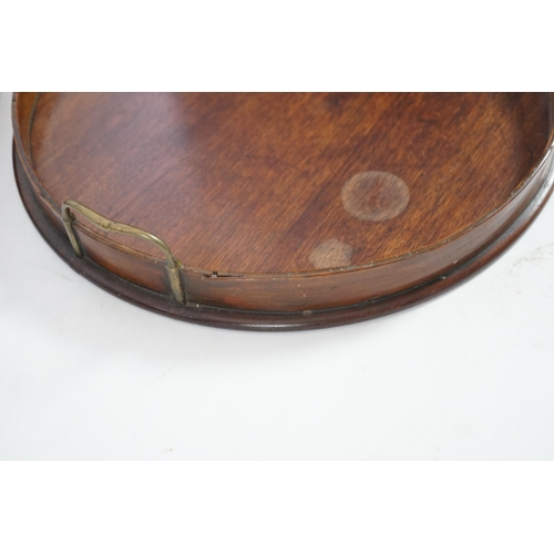 20 - Three George III and later circular mahogany gallery trays, each with brass loop handles, largest di... 