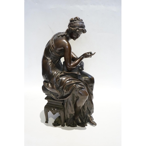 23 - A 19th century French bronze figure of Sappho seated, holding a book and stylus, 34cm high