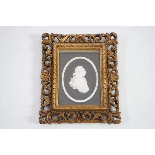 6 - A Tassie style plaster relief of George III, housed in a gilt scroll frame, the relief 7cm, frame 24... 