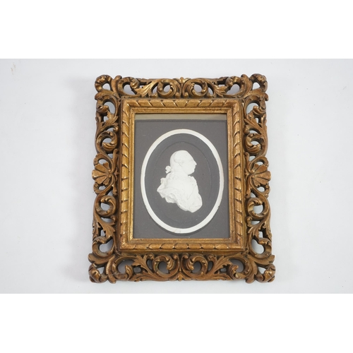 6 - A Tassie style plaster relief of George III, housed in a gilt scroll frame, the relief 7cm, frame 24... 