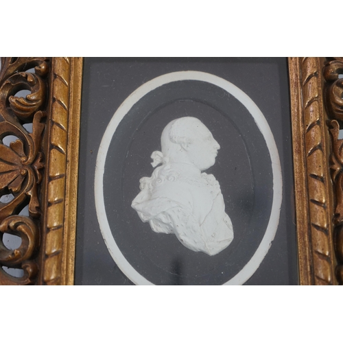 6 - A Tassie style plaster relief of George III, housed in a gilt scroll frame, the relief 7cm, frame 24... 