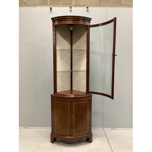 1004 - A reproduction Sheraton style inlaid mahogany bow fronted standing corner cupboard, width 70cm, dept... 