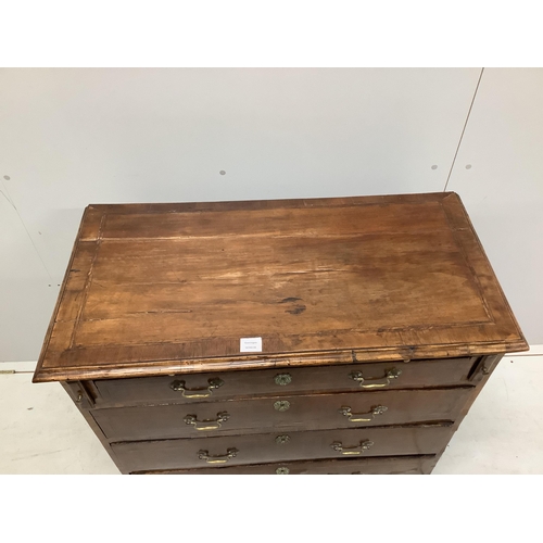 1062 - A mid 18th century feather banded walnut chest, fitted four long drawers, beneath a brushing slide, ... 