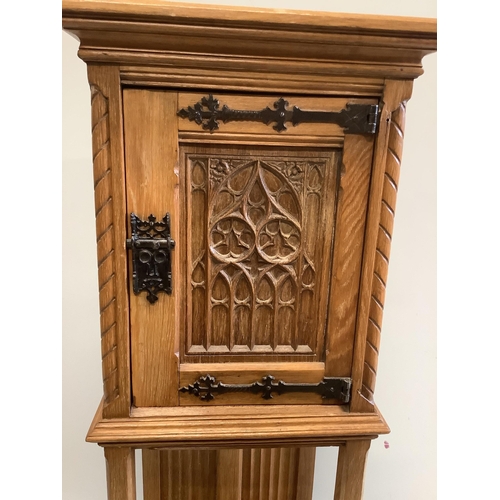 1065 - A Gothic Revival oak cabinet on stand, width 46cm, depth 38cm, height 127cm. Condition - fair