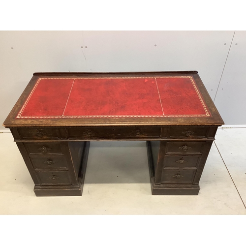 1069 - A late Victorian oak pedestal desk, width 128cm, depth 61cm, height 77cm. Condition - fair