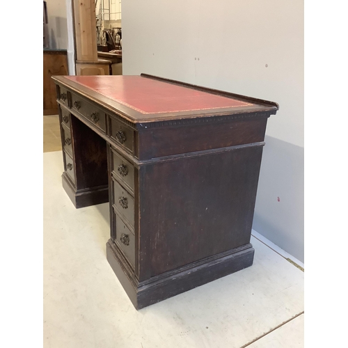 1069 - A late Victorian oak pedestal desk, width 128cm, depth 61cm, height 77cm. Condition - fair