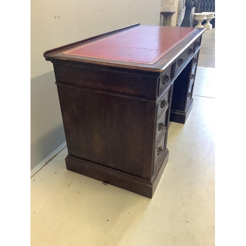 1069 - A late Victorian oak pedestal desk, width 128cm, depth 61cm, height 77cm. Condition - fair