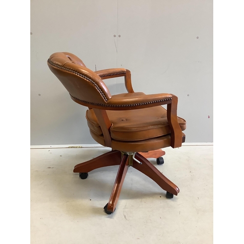 1079 - A modern mahogany and tan leather swivel desk chair, width 60cm, depth 50cm, height 86cm. Condition ... 